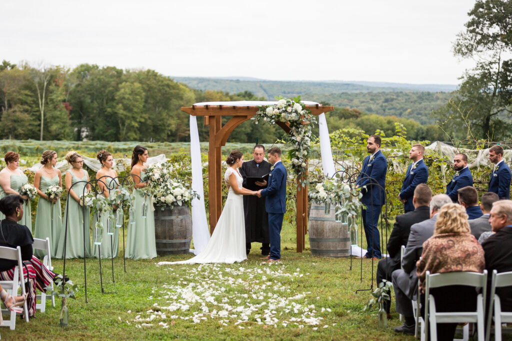 bride and groom taking their vows at an outdoor ceremony at Priam Vineyards